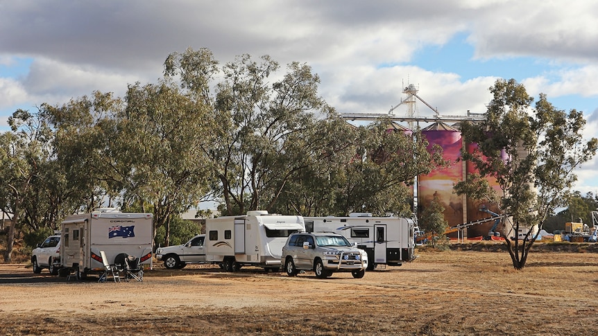 Caravans parked in front of mural