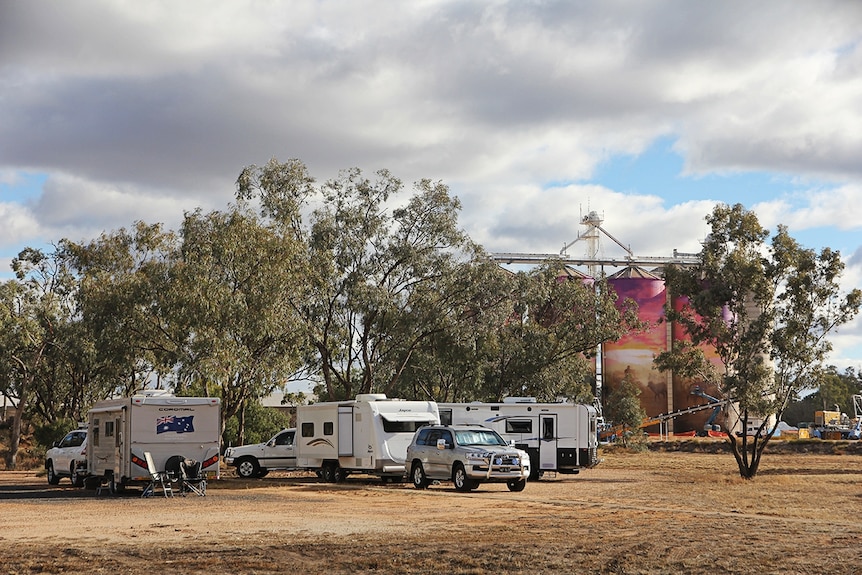 Caravans parked in front of mural