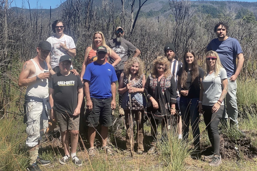 A group of Aboriginal people standing in bushland.