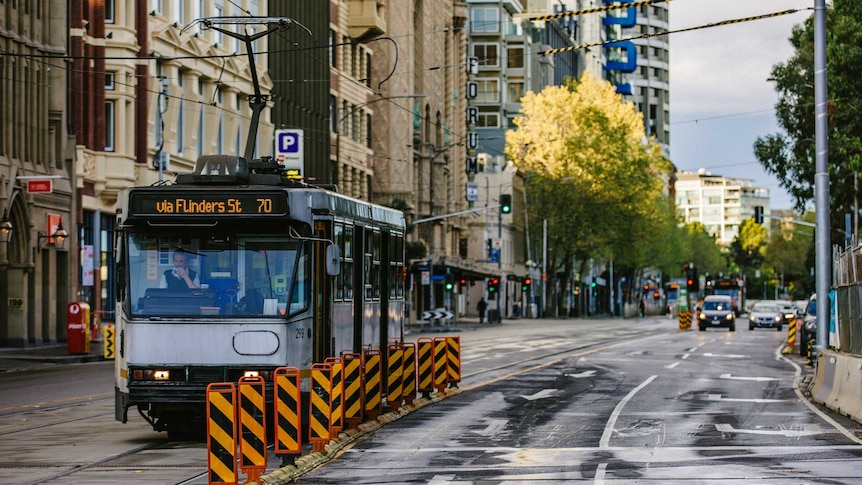 A parked Melbourne tram on an empty street.