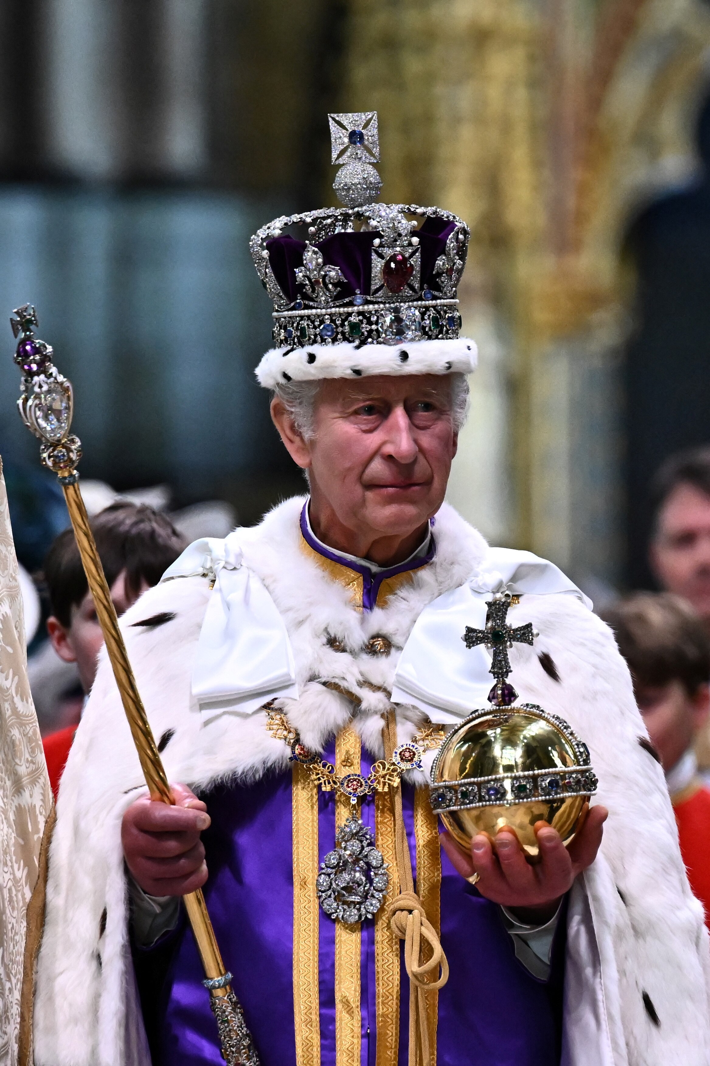 King Charles holds the Sovereign's Orb in his left hand and the Sovereign’s Sceptre with Cross.