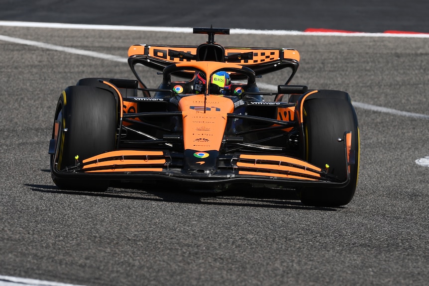 Orange McLaren F1 car on-track, driven by Oscar Piastri during testing in Bahrain.