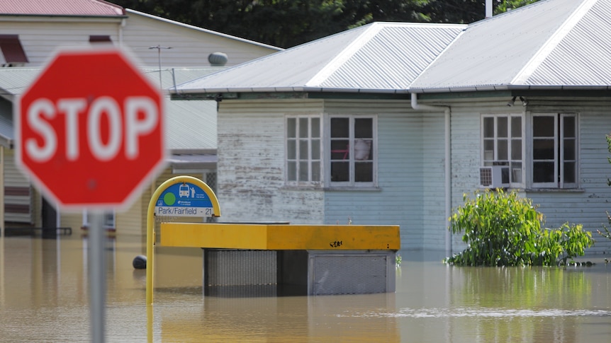 A house sits in high flood waters.