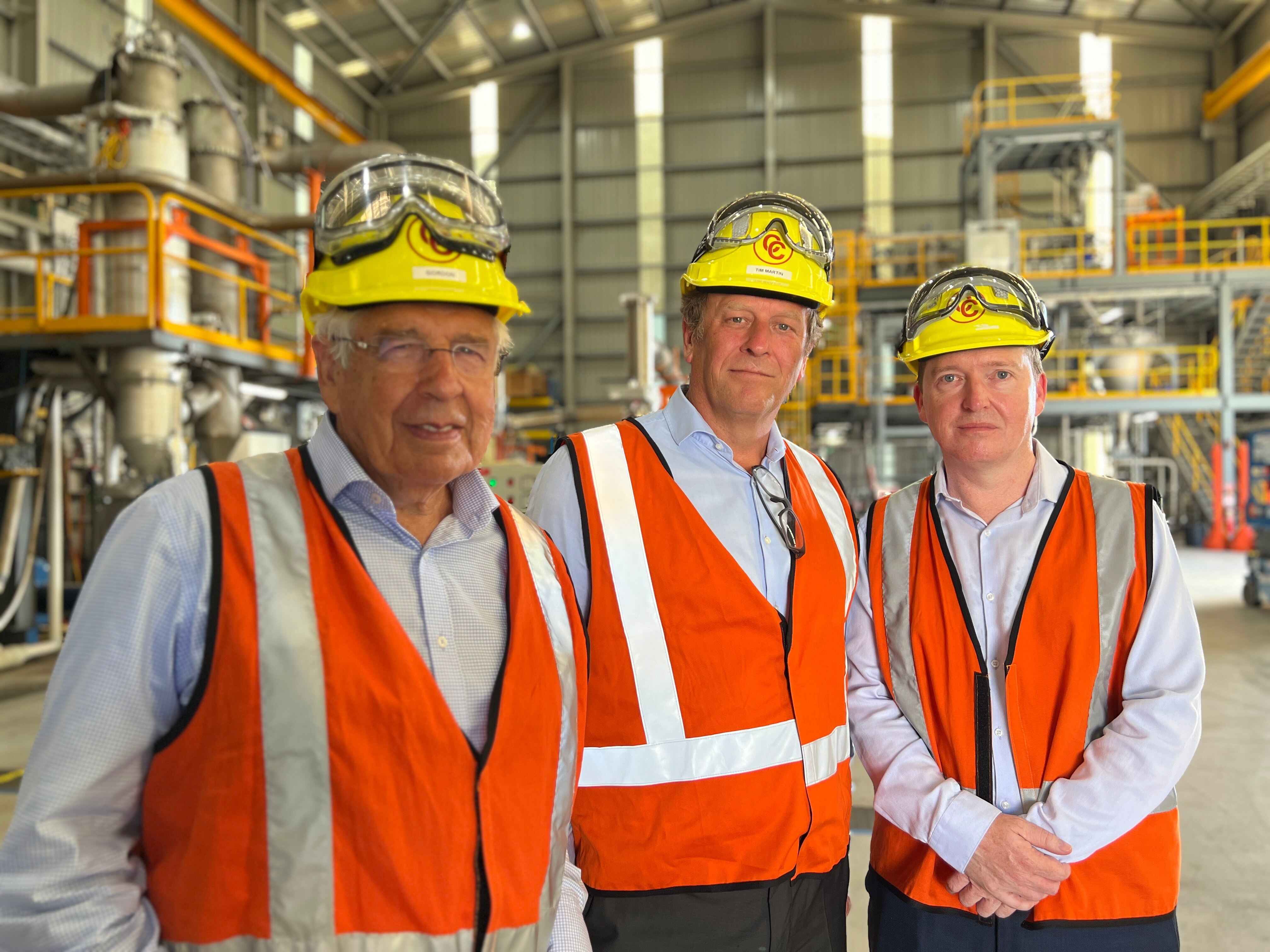 Three men in high-vis vests and hard hats. 