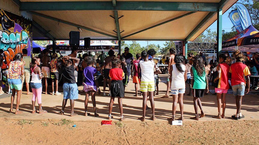 Local schoolchildren perform a traditional dance at the Mornington Island PCYC as part of a health awareness event.