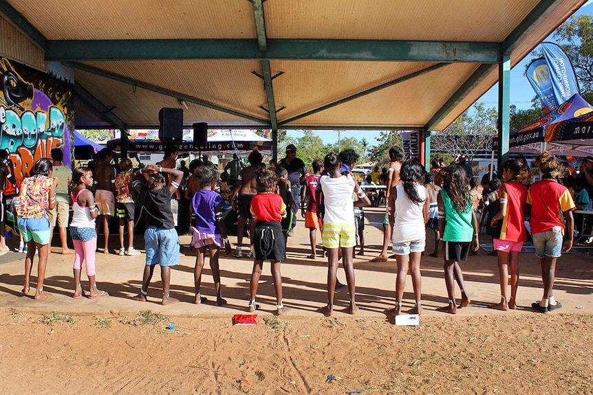 Local schoolchildren perform a traditional dance at the Mornington Island PCYC as part of a health awareness event.