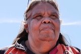 indigenous woman looking out of frame