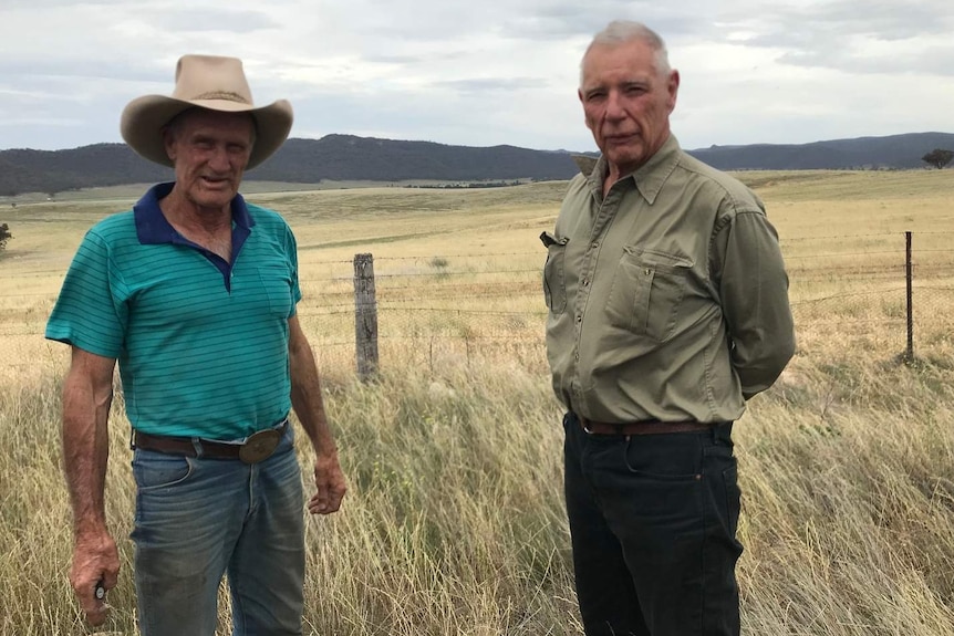 Two farmers in pastures in the Bylong Valley in NSW