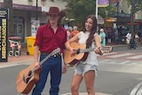 Jarrad and Tyla standing on Peel street, Tamworth with their guitars in hand