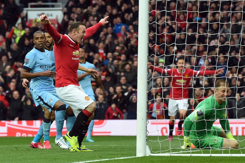 Wayne Rooney celebrates a goal against Manchester City