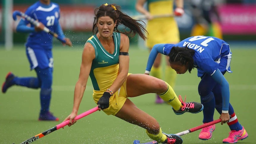 Anna Flanagan falls as she is tackled during match against Malaysia