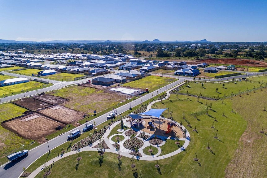 Riverbank from the air, showing a new housing development and nearby parks.