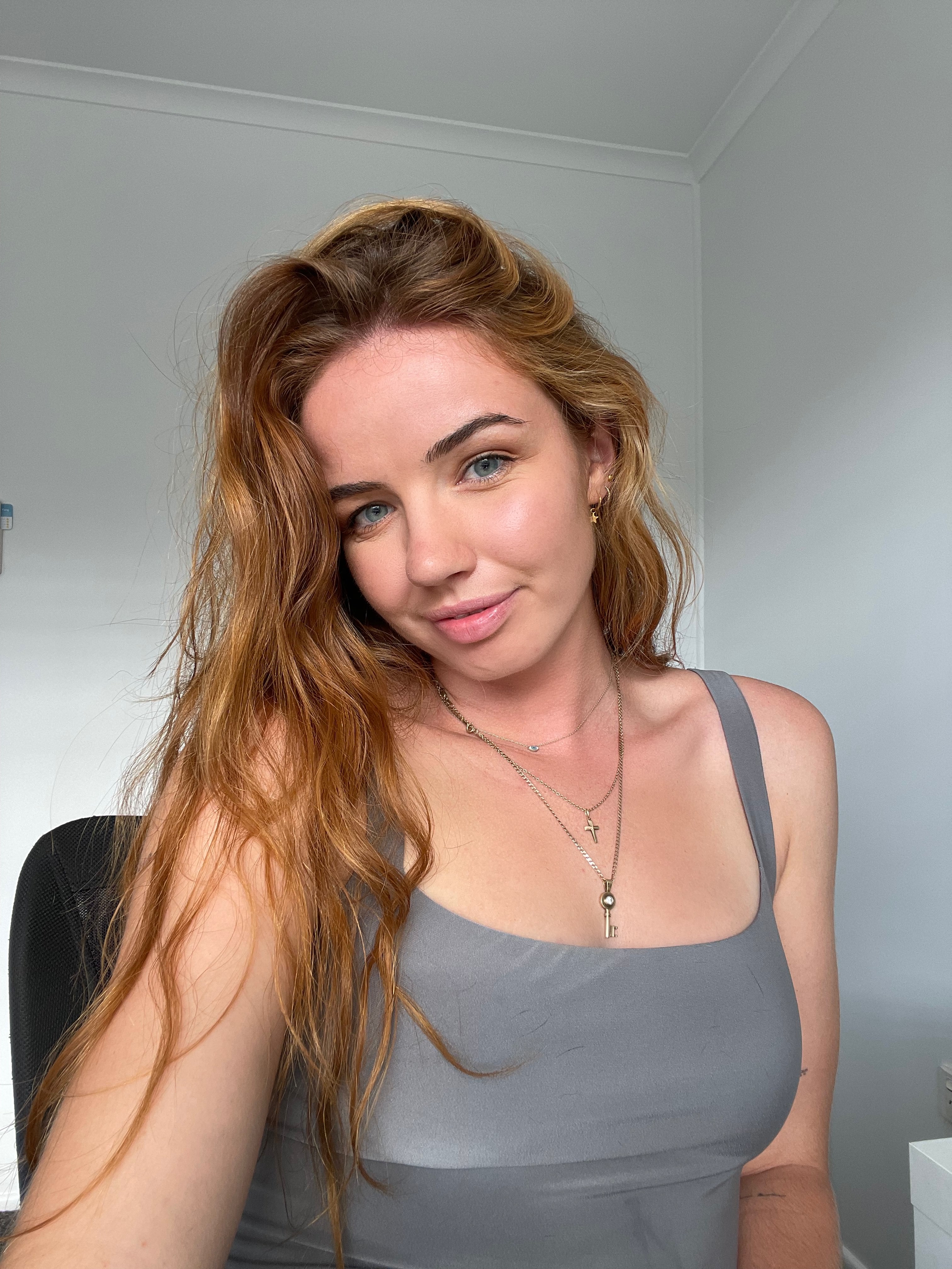 A selfie of a blonde girl with blue eyes. 