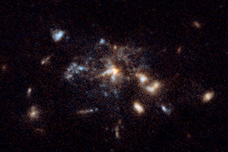 A fuzzy image of a galaxy - looks like specks of strangely shaped light on a black background