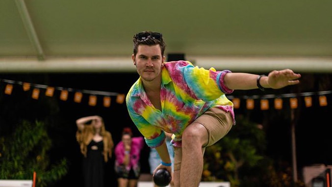 A photo of Hamish Harty about to play a game of bowls.