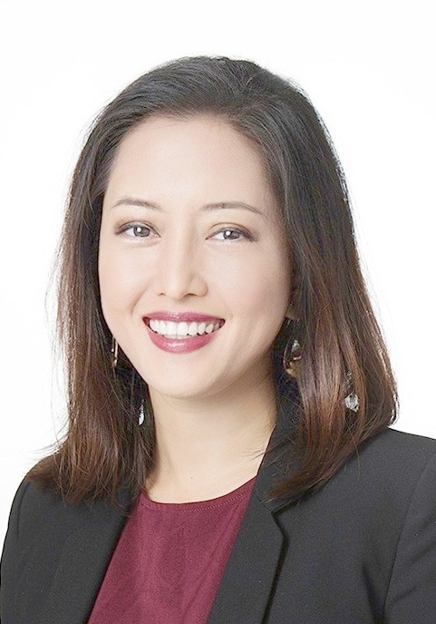 A Malaysian woman smiles while posing for a professional portrait