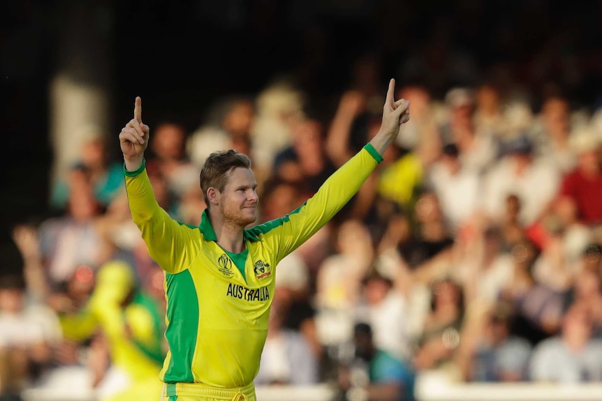 Australia's Steve Smith points his fingers to the sky after taking a wicket against New Zealand at the Cricket World Cup.