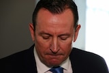 A tight head and shoulders shot of WA Premier Mark McGowan looking downcast during a media conference.