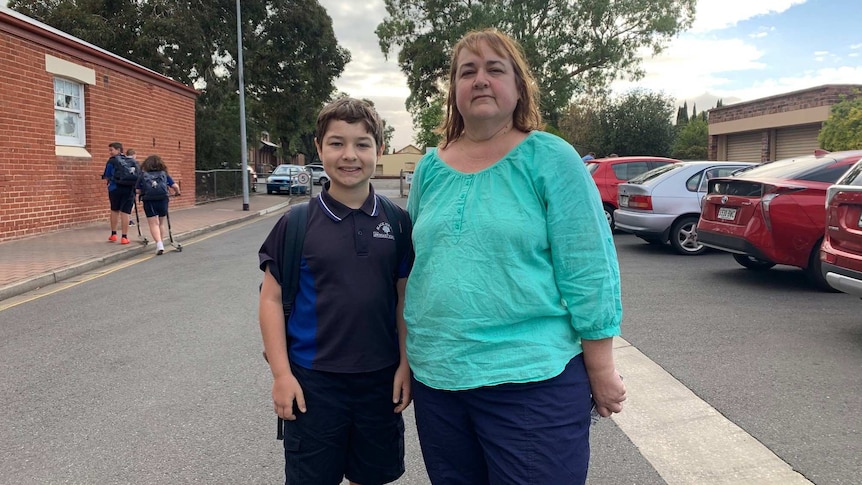 A mother and son in a school car park