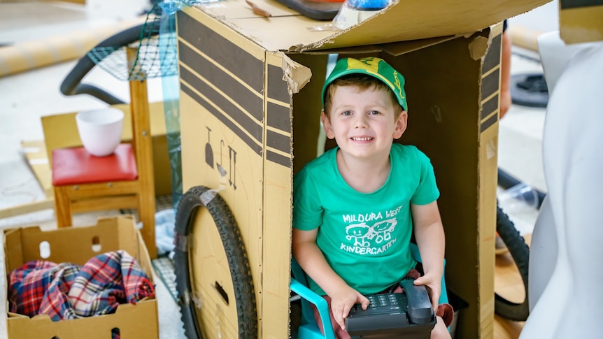 Boy sitting in box