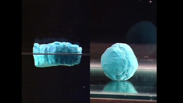 Two blobs of plasticine on glass, one flattish, one in a ball