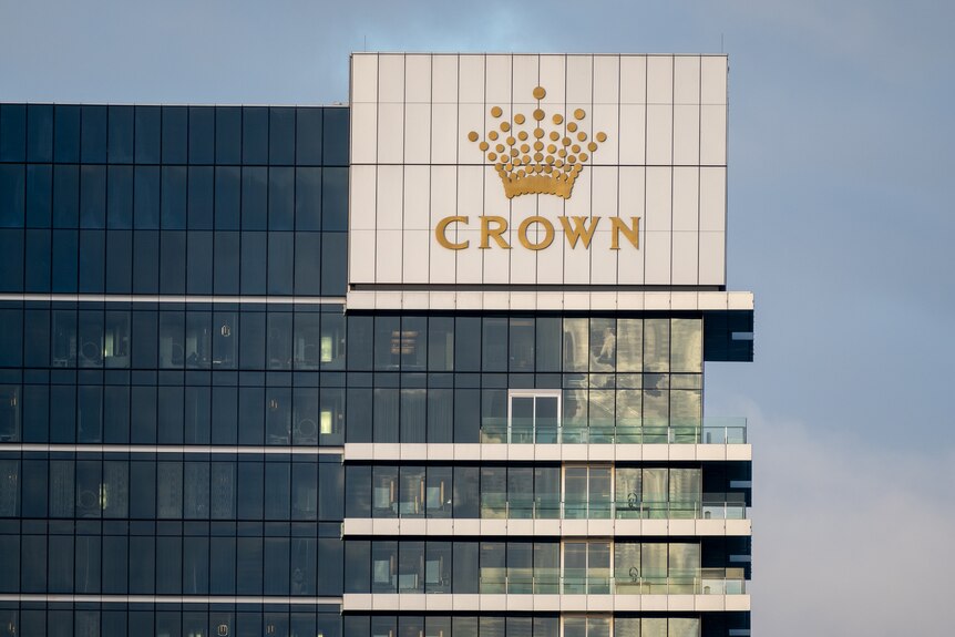 A close-up shot of the top floors of Crown Towers Perth with a big logo visible on the top right corner.