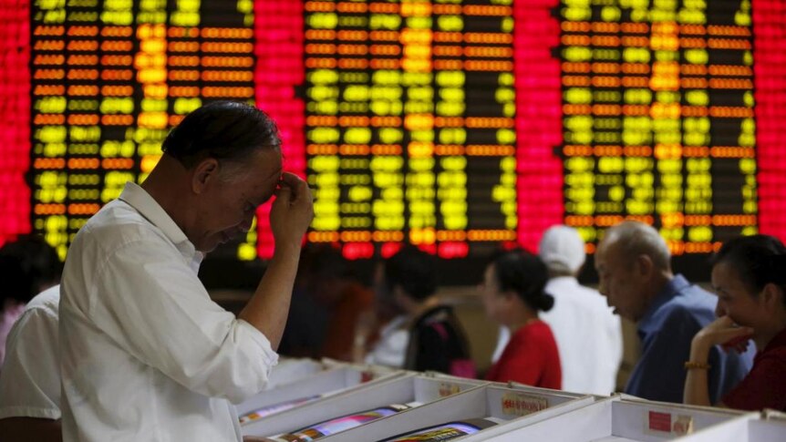 Investors look at computer screens showing stock information at a brokerage house in Shanghai, China, July 8, 2015.