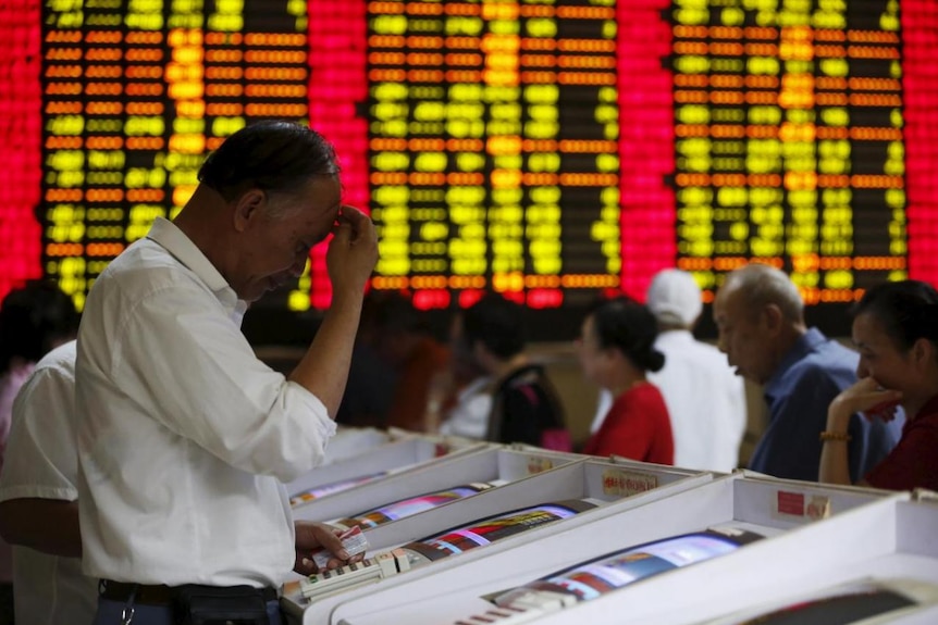 Investors look at computer screens showing stock information at a brokerage house in Shanghai, China, July 8, 2015.