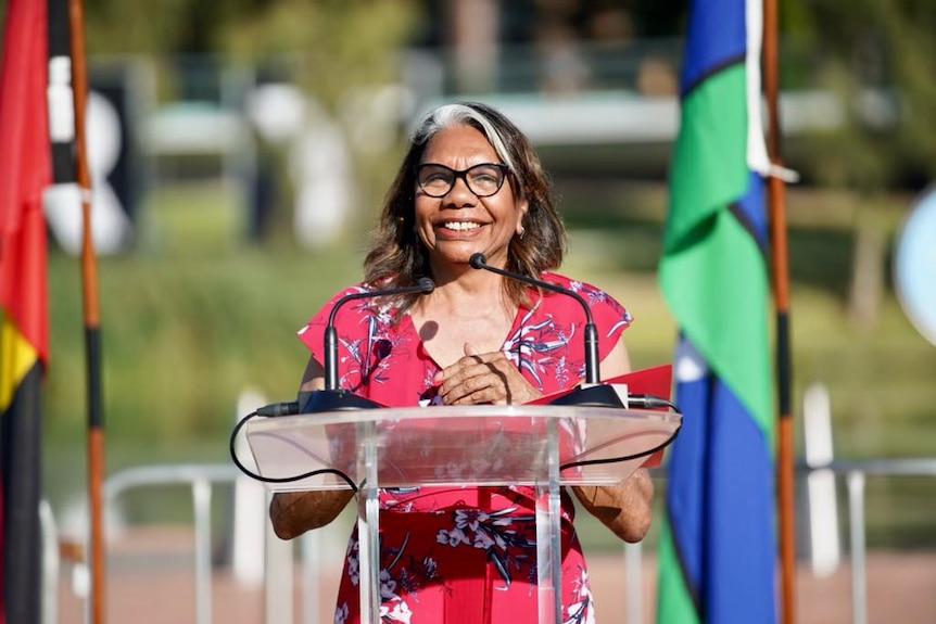 Kaurna Elder Rosemary Wanganeen smiling and standing behind a podium