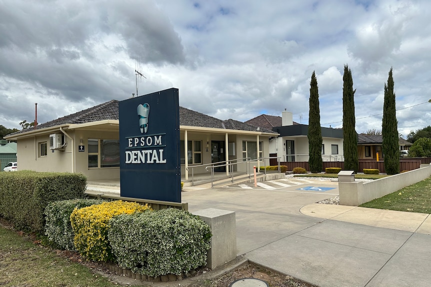 The outside of a dental surgery, with a sign out the front saying 'Epsom Dental'.