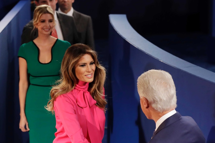 Bill Clinton shakes hands with Melania Trump, wife of Donald Trump before the second presidential debate