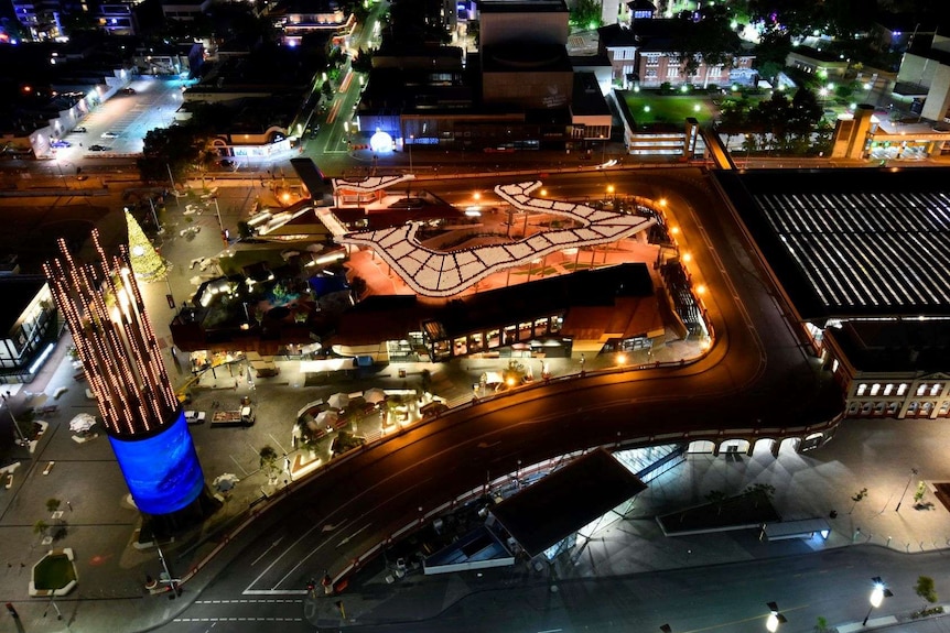An aerial view of a lit up Yagan Square at night