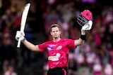 A man celebrates after scoring a century in a T20 match