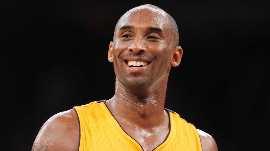 Kobe Bryant wearing a Lakers jersey and smiling