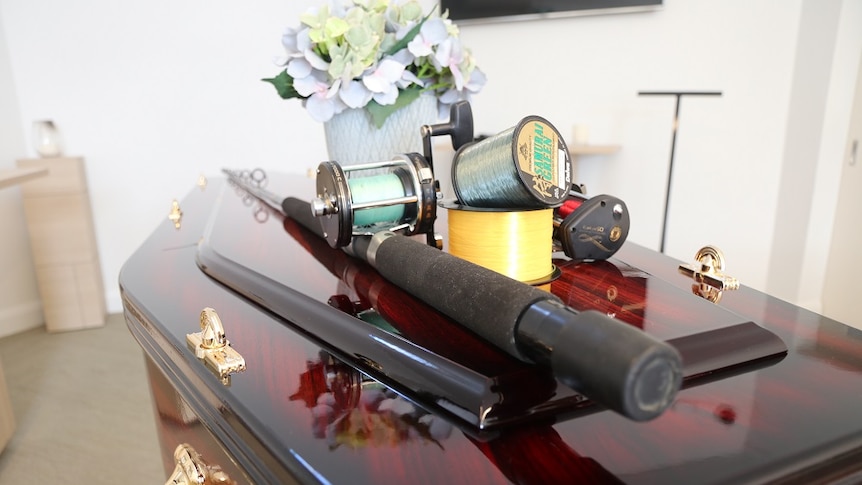 A fishing rod on a coffin