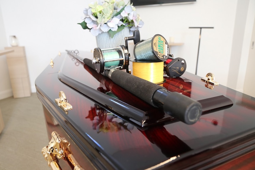 A fishing rod on a coffin