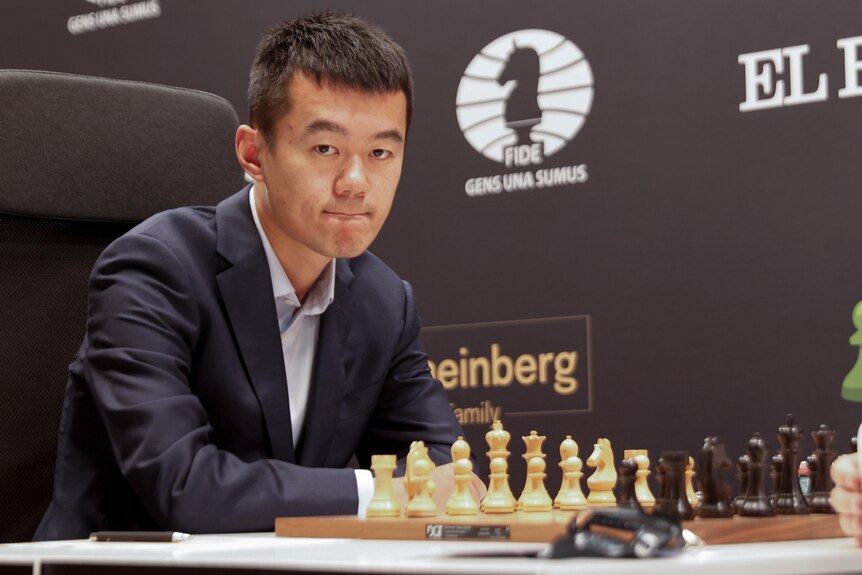 Ding Liren waits to start a chess game with Ian Nepomniachtchi