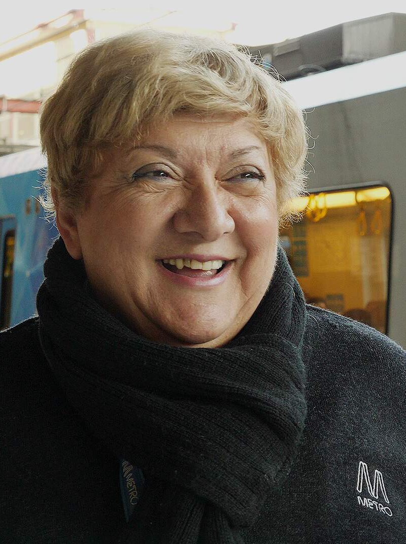 Joanne Pearson smiles as a train goes by in the background