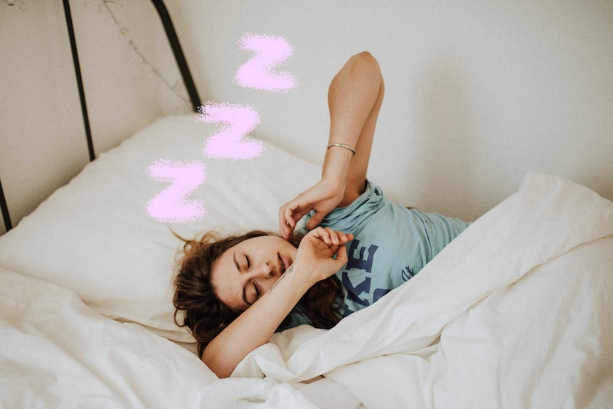 Woman spending her time sleeping in bed, with sleeping symbols above her head.
