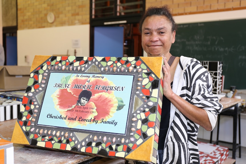 Rolene Ferguson holds a headstone she made for her mother Irene Ferguson.