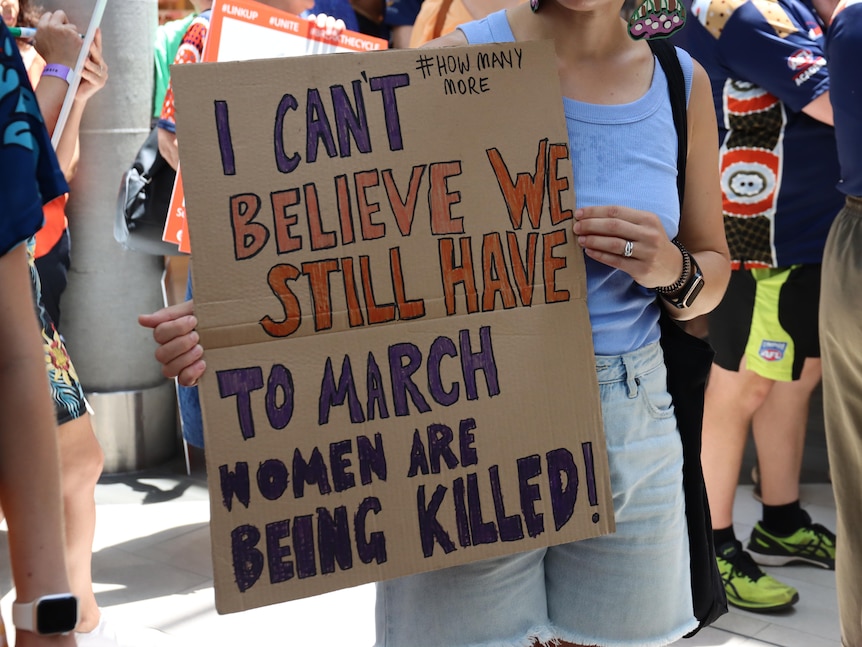 A placard at a march saying 'I can't believe we still have to march, women are being killed!'