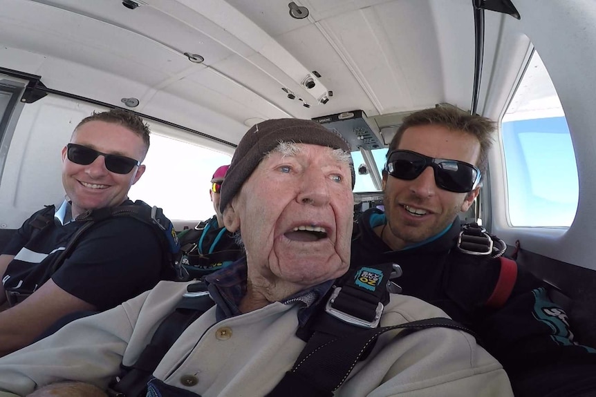 Sam Westwood looking out the window of a plane before skydiving