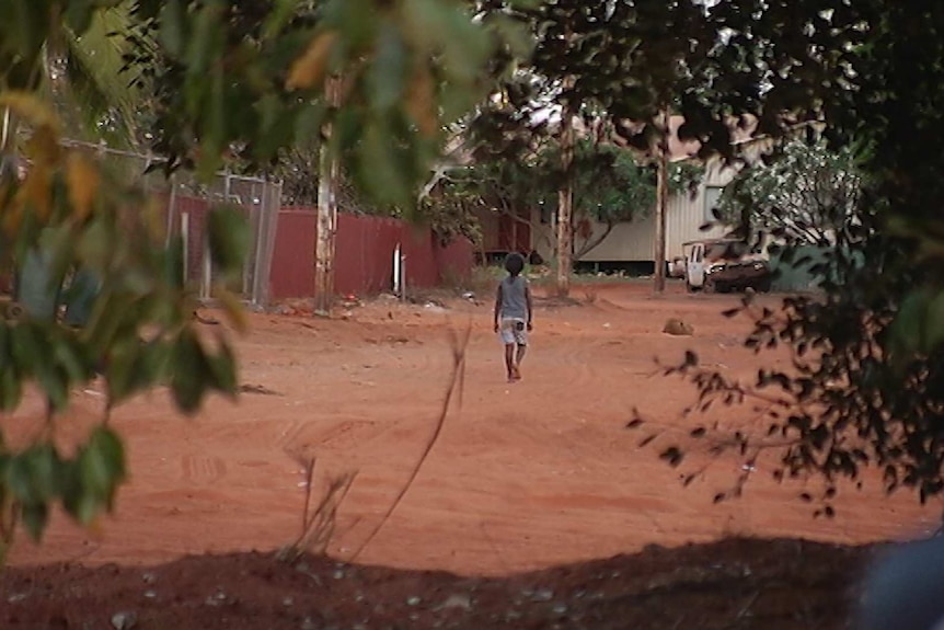 A small child walks through the Djarindjin remote community.