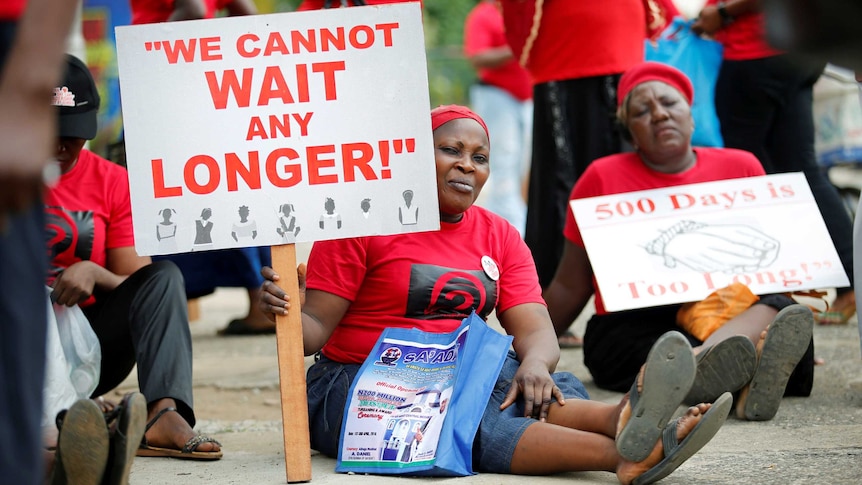 Women carrying placards attend a street protest campaigning for the rescue of abducted Chibok girls.