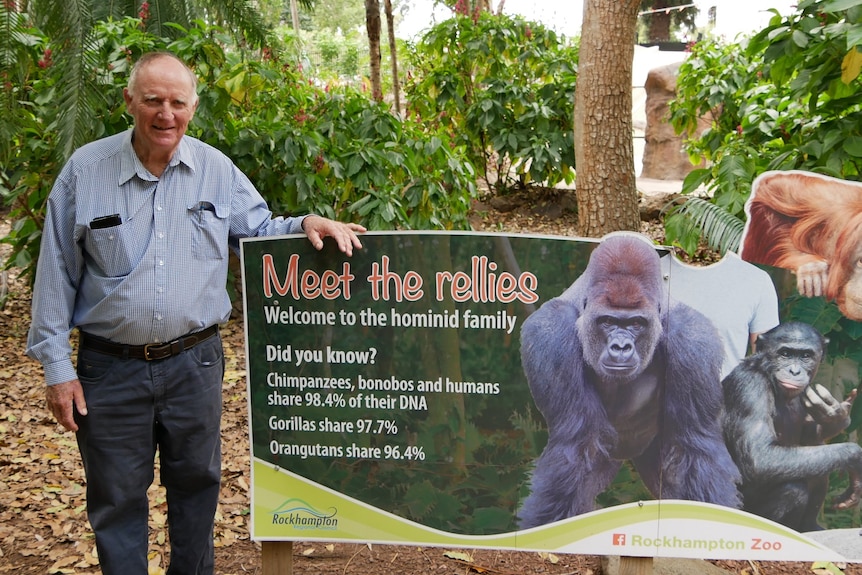 Tom Wyatt stands next to a sign that says 'meet the rellies' and features a picture of a chimpanzee.