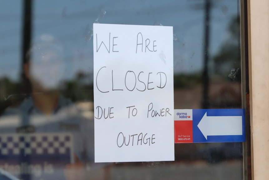 A sign says 'We are closed due to the power outage'