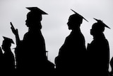 A silhouette shows graduate students wearing gowns and hats.