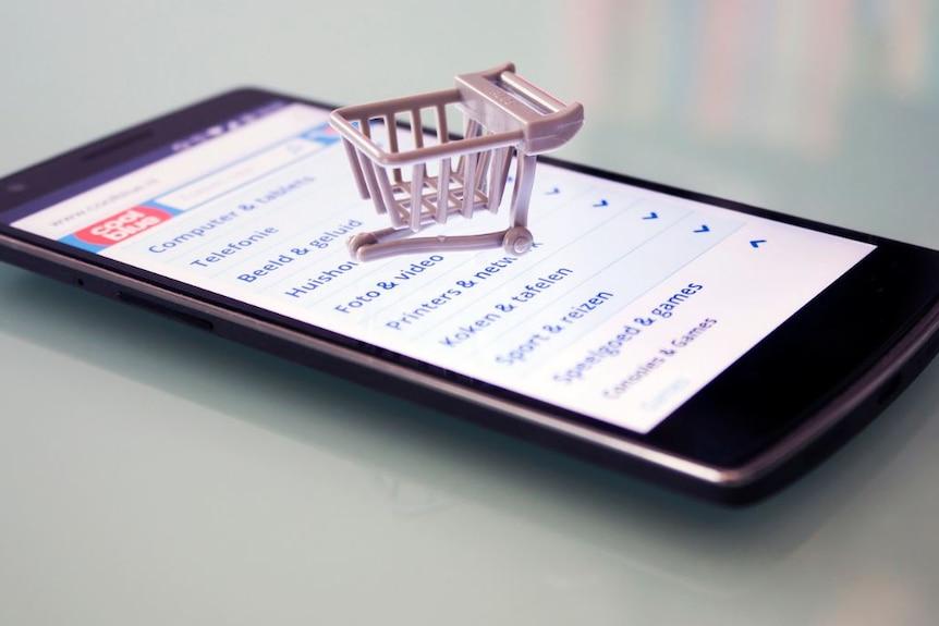An iphone with a small shopping cart on it