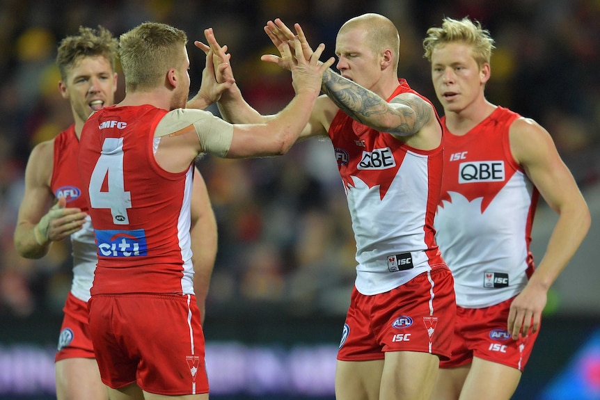 Dan Hannebery and Zake Jones give each other a high five after a Sydney Swans goal.