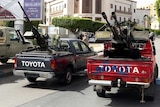 Vehicles mounted with anti-aircraft guns stand outside the foreign ministry.